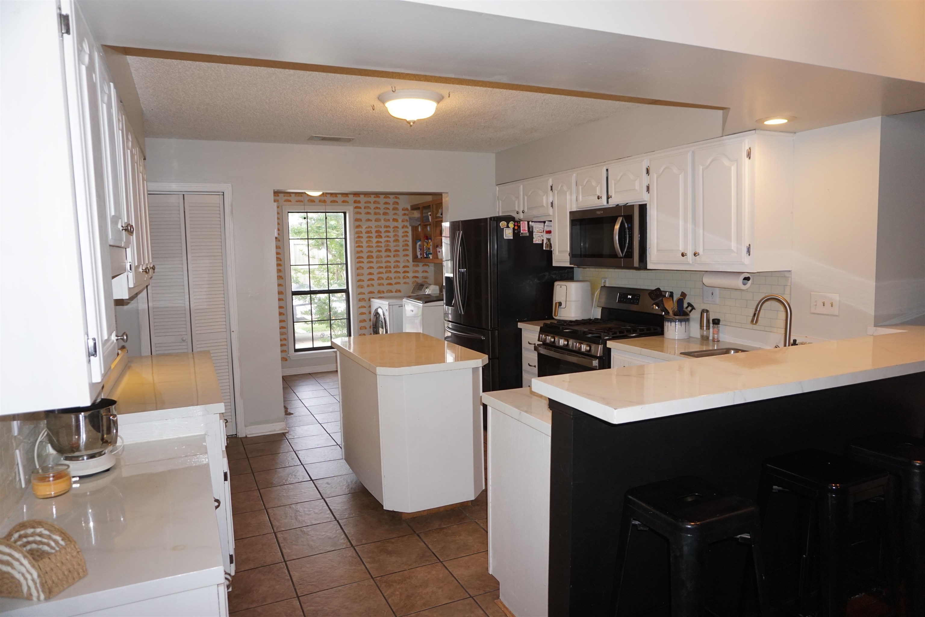 3780 Meade Lake Road Millington, TN 38053 - Photo 12 of 40 Kitchen with appliances with stainless steel finishes, washer and dryer, a peninsula, a sink, and backsplash