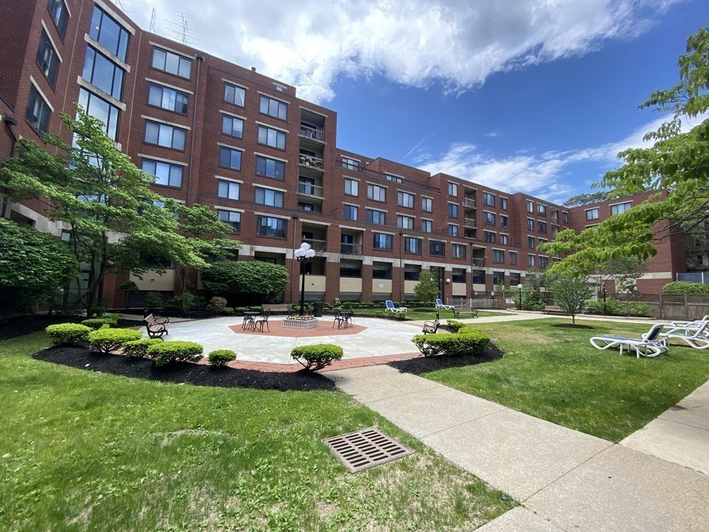 85 Brainerd Road, Unit 510 Boston, MA 02134 - Photo 21 of 25 a view of a building with garden and trees