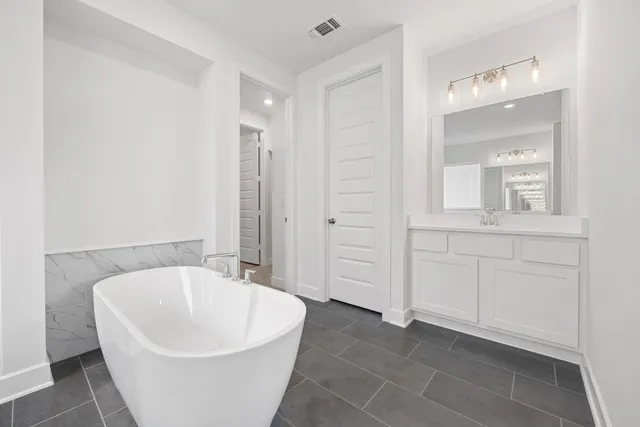 a white bath tub sitting in a en suite bathroom