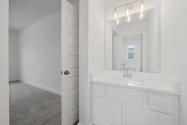 a view of a house with a big yard potted plants and large tree