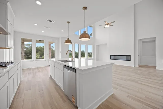 a kitchen with granite countertop a stove and a wooden floors