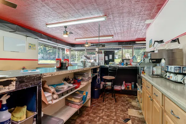 a kitchen with stainless steel appliances granite countertop a sink and wooden cabinets