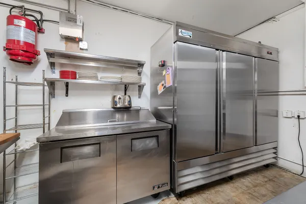 a kitchen with a refrigerator and a sink