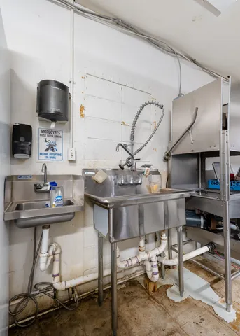 a kitchen with a sink cabinets and appliances