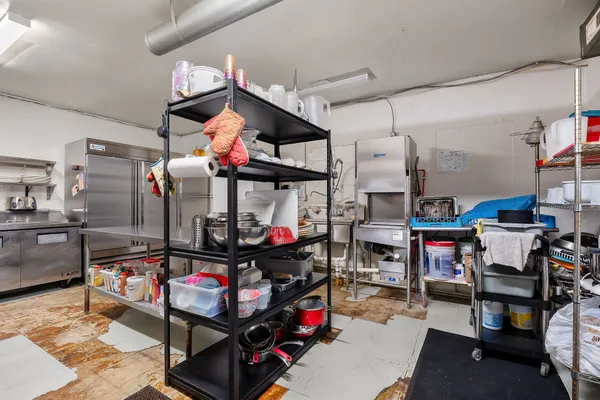 a store room with lots of furniture and clutter