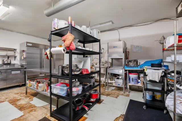 a store room with lots of furniture and clutter