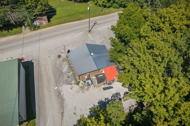 an aerial view of a house with a yard and lake view