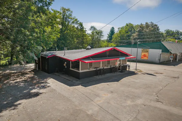 an aerial view of ocean with residential house and outdoor space