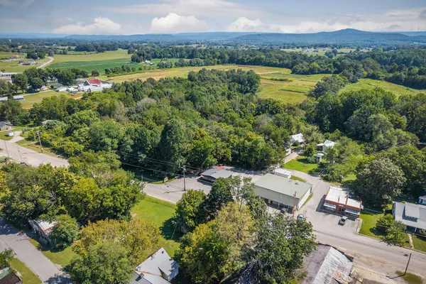 an aerial view of a house with a garden and lake view