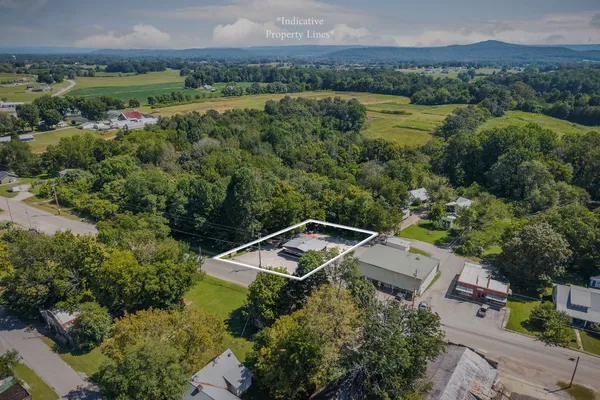 an aerial view of a house with garden space and street view