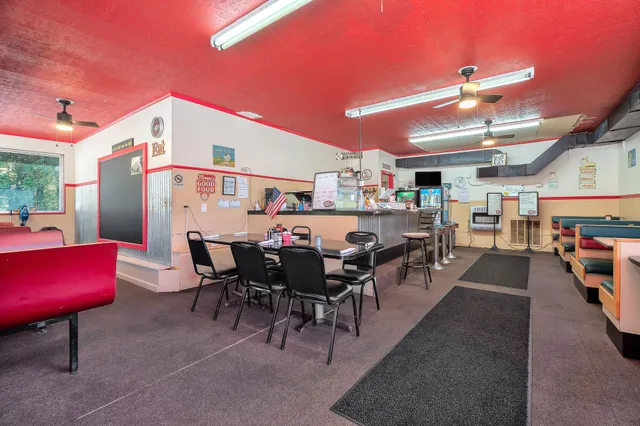 a dining hall with furniture and a rug