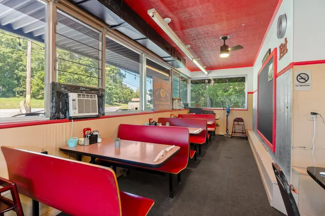 a bedroom with furniture and a large window
