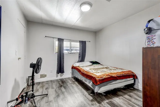 a bedroom with a bed and dresser