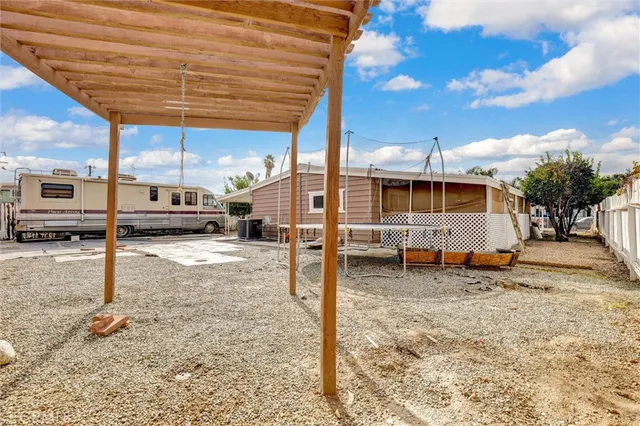 a view of a backyard with sitting area