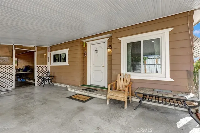 a backyard of a house with barbeque oven table and chairs