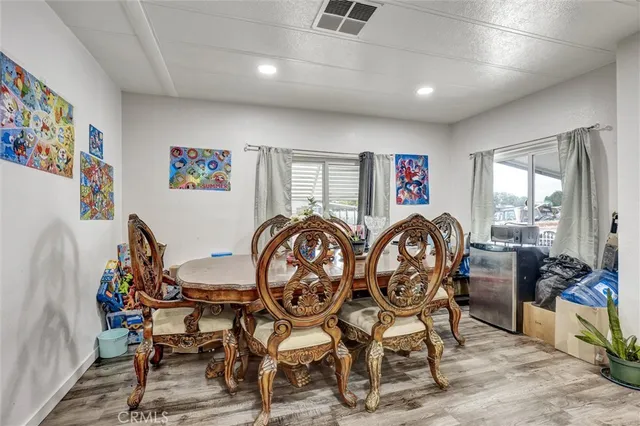 a dining room with furniture a rug and wooden floor