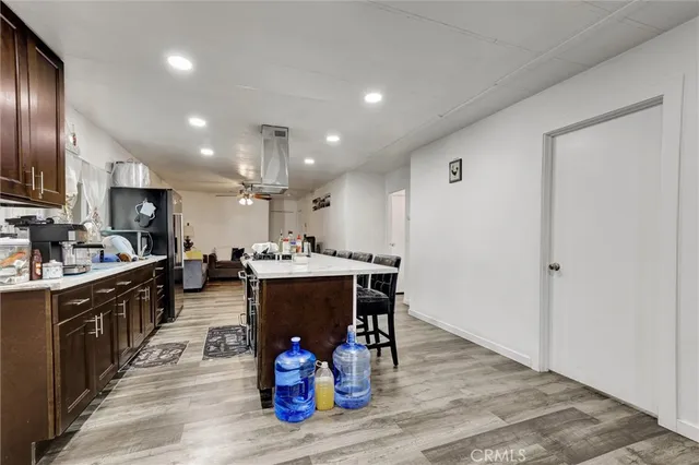 a kitchen with a sink appliances and wooden floor