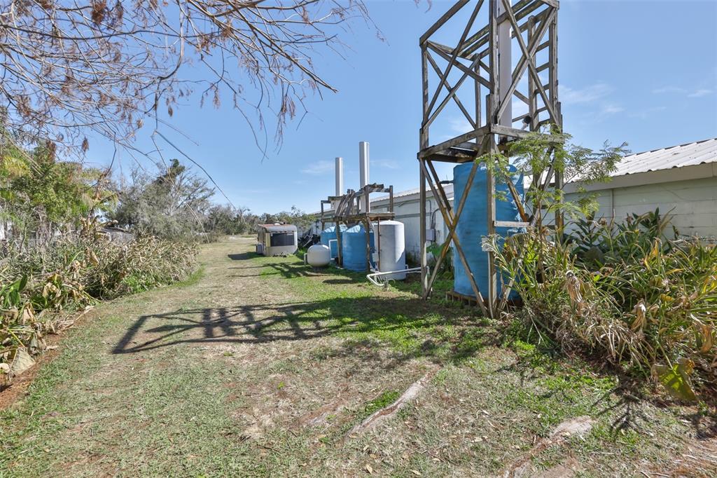 20112 Hobbs Road Wimauma, FL 33598 - Photo 59 of 94 a backyard of a house with lots of green space