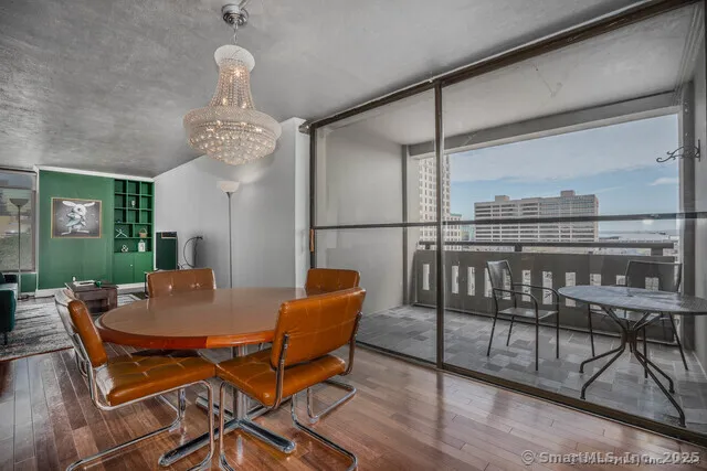 a view of a dining room with furniture wooden floor and chandelier