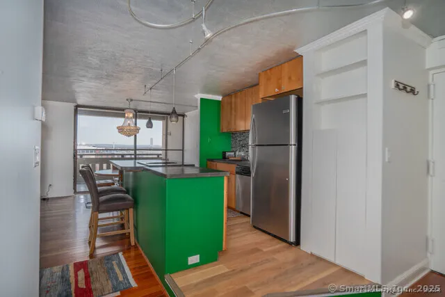 a kitchen with a refrigerator and a table