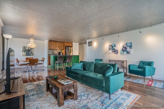 1 Gold Street, Unit 11E Hartford, CT 06103 - Photo 7 of 21 a living room with furniture and a fireplace