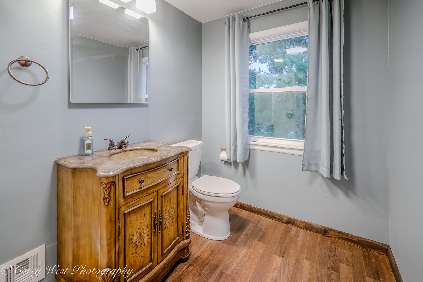 8994 Highway 64 Sycamore, IL 60178 - Photo 23 of 37 a bathroom with a sink a toilet and a mirror