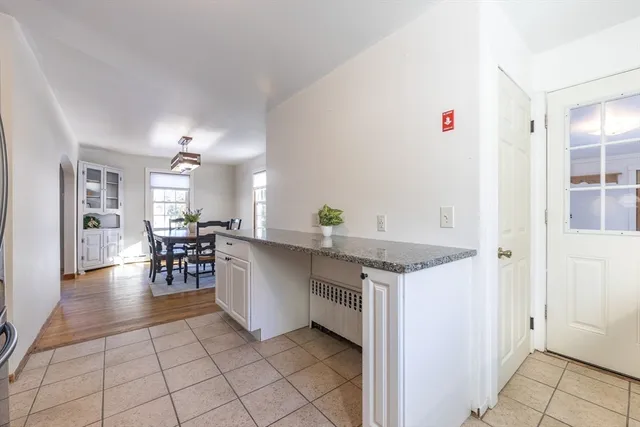 a kitchen with a sink and chairs