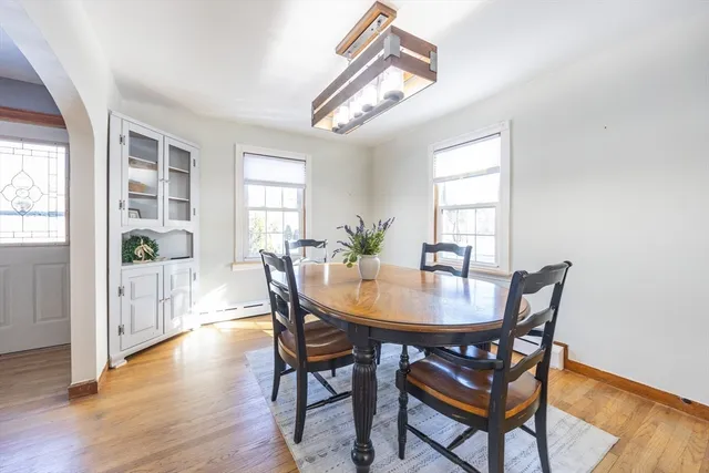 a view of a dining room with furniture and wooden floor