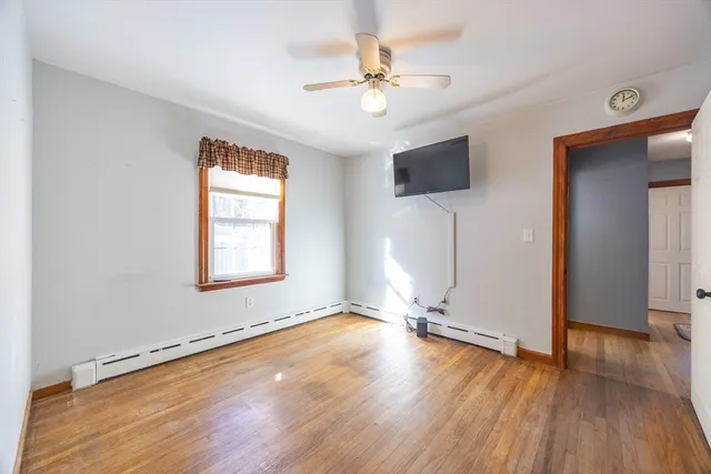 a view of an empty room with wooden floor