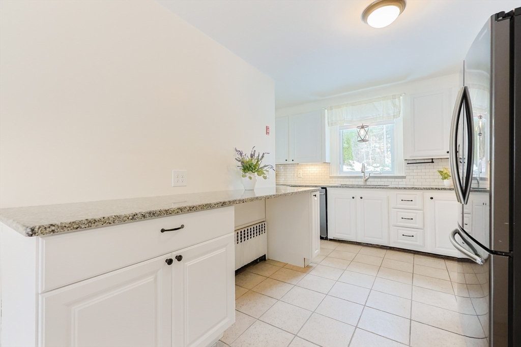 279 South Main Street Hopedale, MA 01747 - Photo 9 of 42 a kitchen with granite countertop white cabinets and white appliances