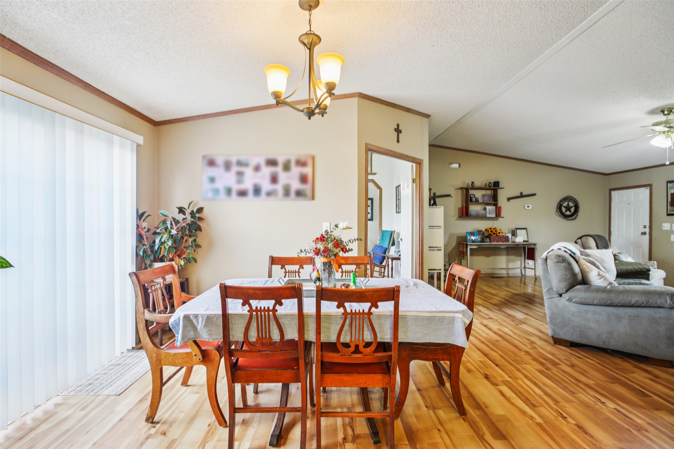 372 Hofferek Road Rosanky, TX 78953 - Photo 9 of 40 Dining room featuring crown molding, light wood-style flooring, a textured ceiling, vaulted ceiling, and a chandelier