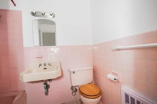 a bathroom with a sink mirror and toilet