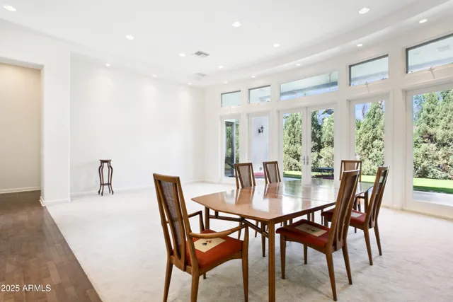 a dining room with furniture and wooden floor