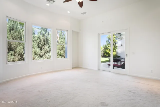 an empty room with windows and garden