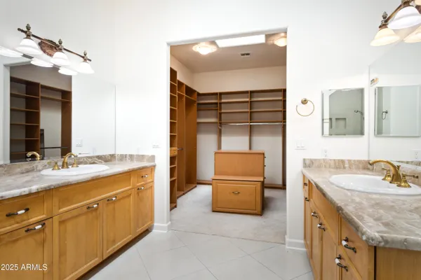a bathroom with a sink double vanity and a mirror