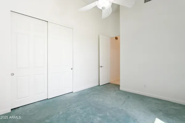 an empty room with a ceiling fan