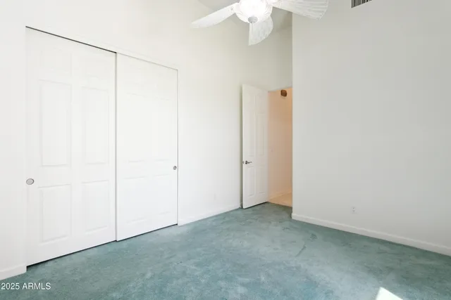 an empty room with a ceiling fan
