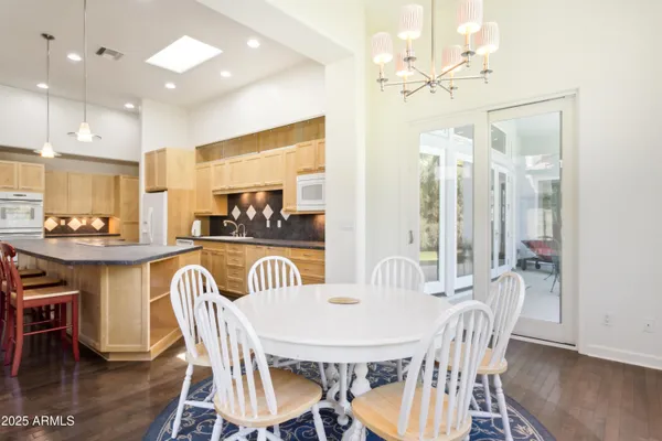 a view of a a dining room with furniture window and wooden floor