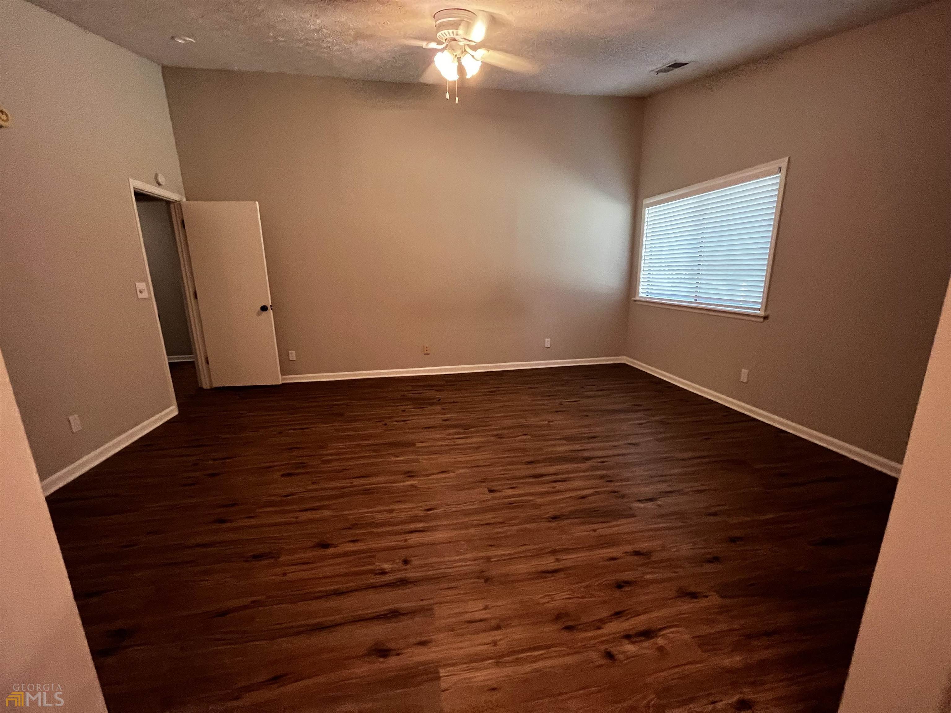 320 Broken Lance Place Alpharetta, GA 30022 - Photo 13 of 18 wooden floor in an empty room
