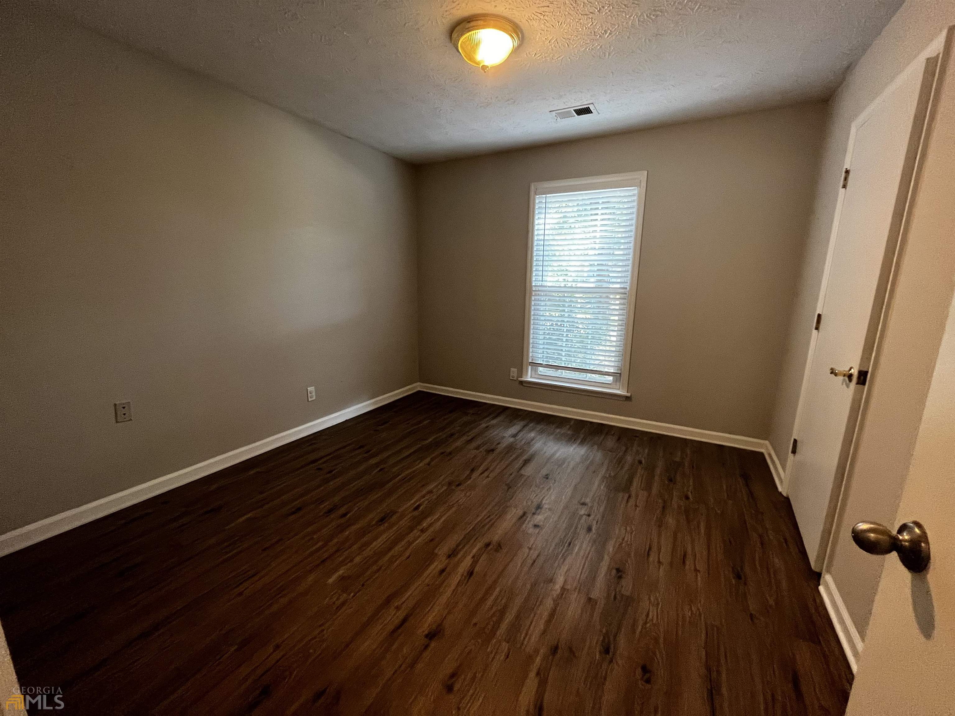 320 Broken Lance Place Alpharetta, GA 30022 - Photo 14 of 18 wooden floor in an empty room with a window