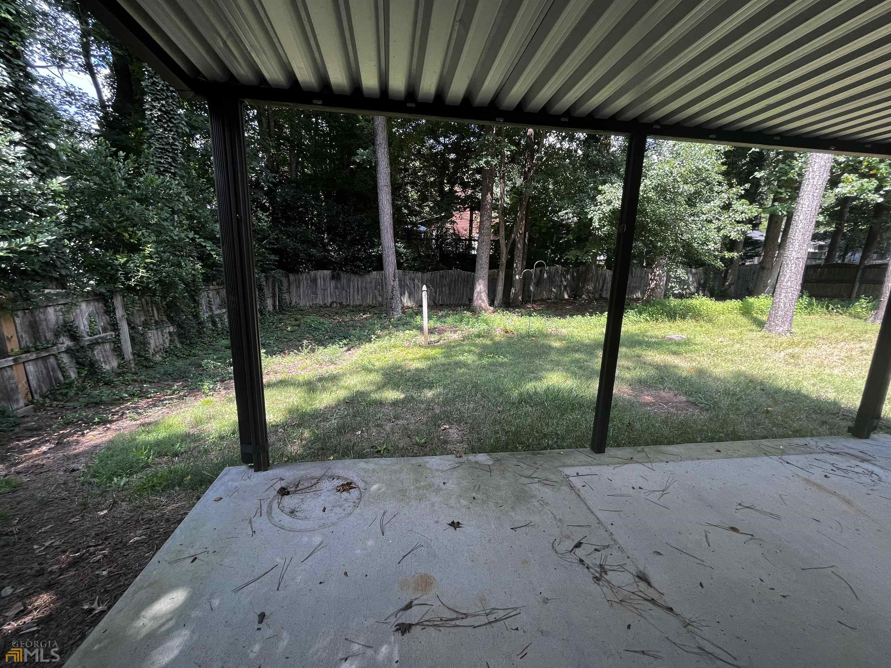 320 Broken Lance Place Alpharetta, GA 30022 - Photo 17 of 18 a view of a backyard with floor to ceiling window and tree