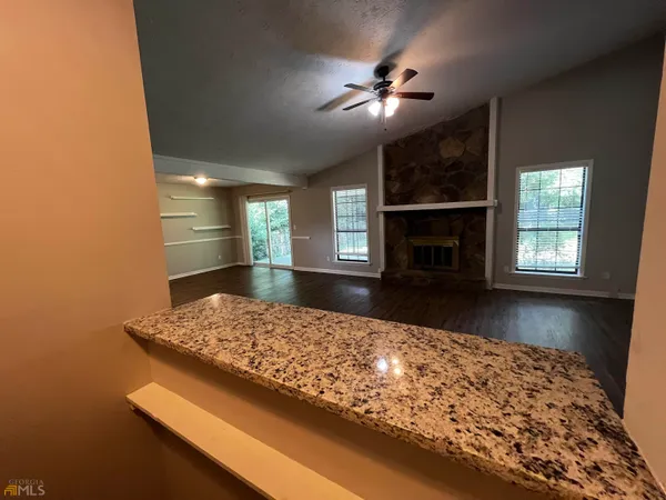 a view of kitchen with fireplace and window