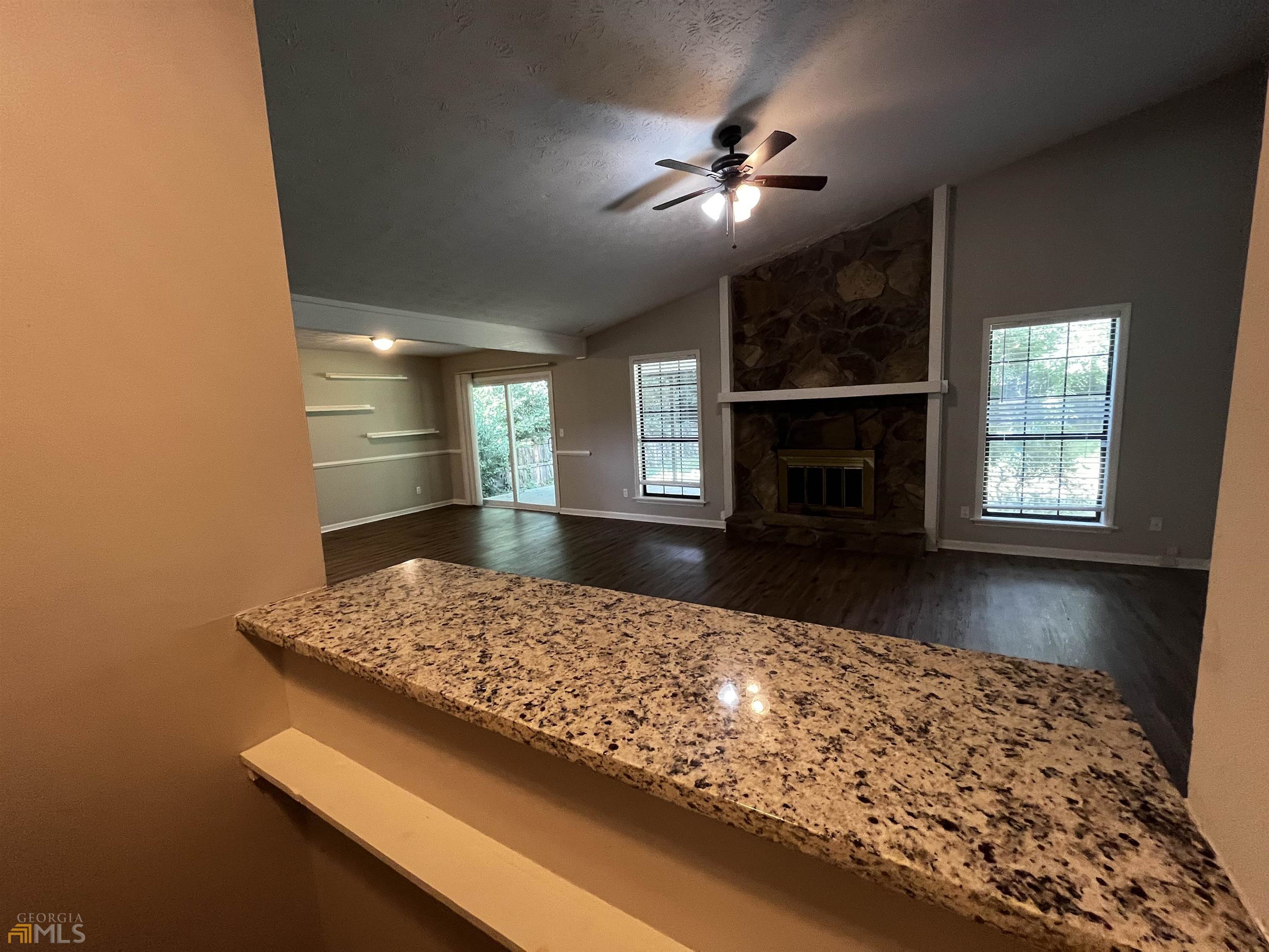 320 Broken Lance Place Alpharetta, GA 30022 - Photo 5 of 18 a view of kitchen with fireplace and window
