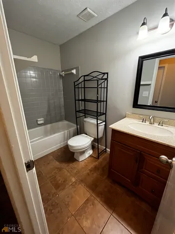 a bathroom with a sink a mirror and a shower