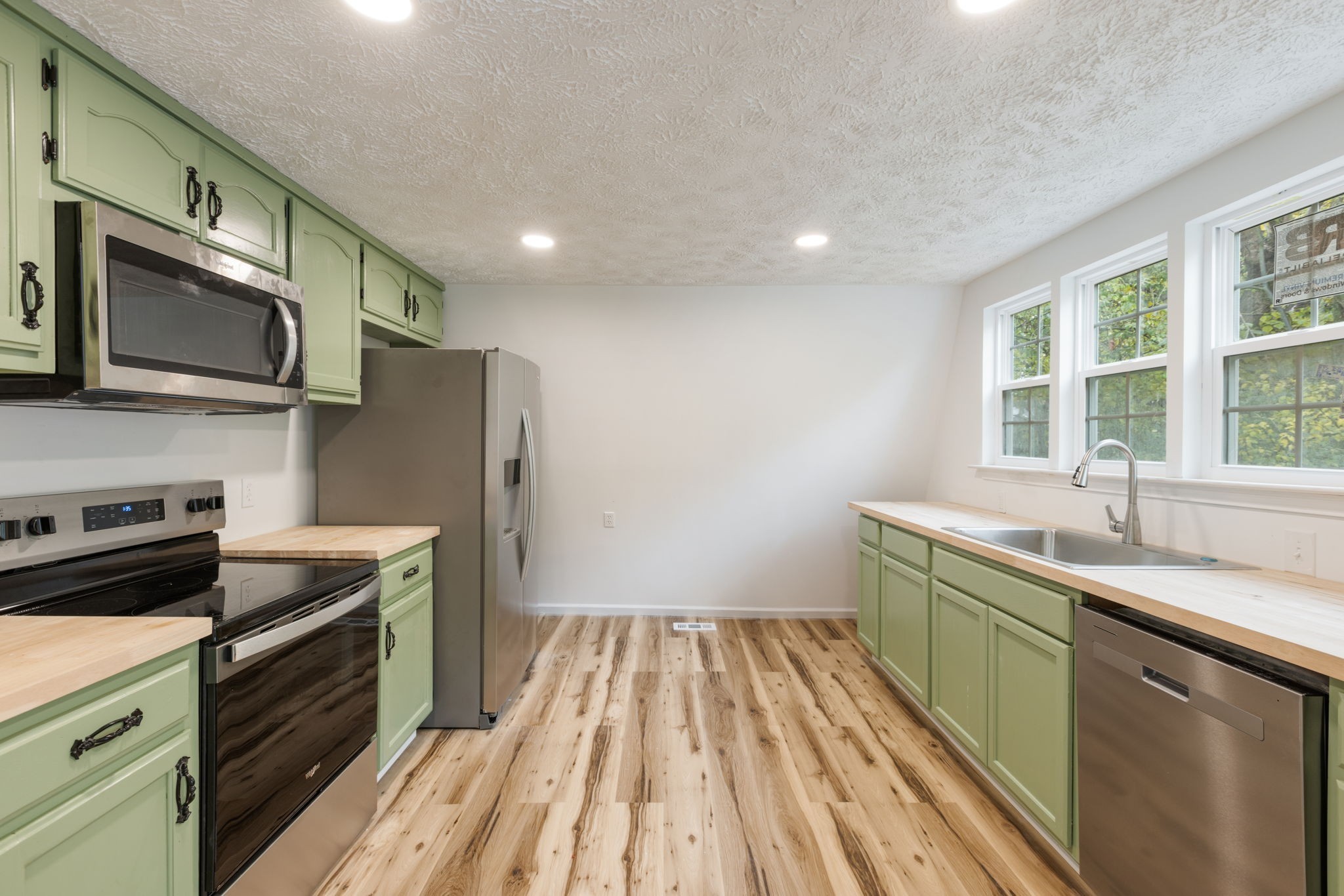 415 Durrett Street Springfield, TN 37172 - Photo 23 of 54 a kitchen that has a sink wooden floor stainless steel appliances and cabinets