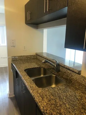 a kitchen with a sink and granite top