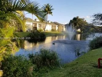 a view of a house with a lake from a yard