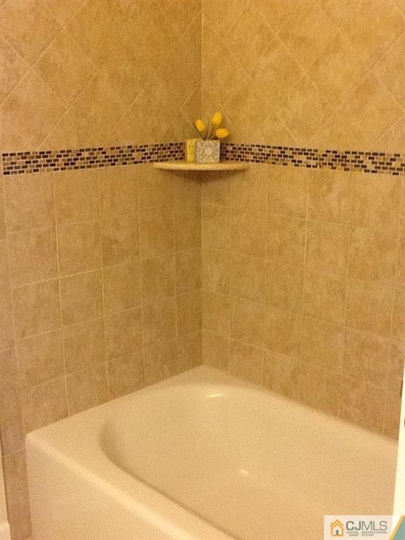 32 Boulder Drive, Unit 32 Edison, NJ 08817 - Photo 17 of 24 a bathroom with a tub and shower