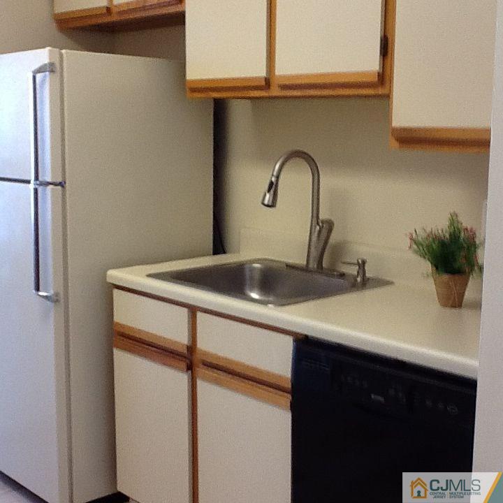 32 Boulder Drive, Unit 32 Edison, NJ 08817 - Photo 7 of 24 a bathroom with a sink and mirror