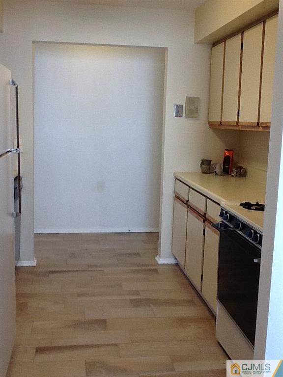 32 Boulder Drive, Unit 32 Edison, NJ 08817 - Photo 8 of 24 a kitchen with a sink and cabinets